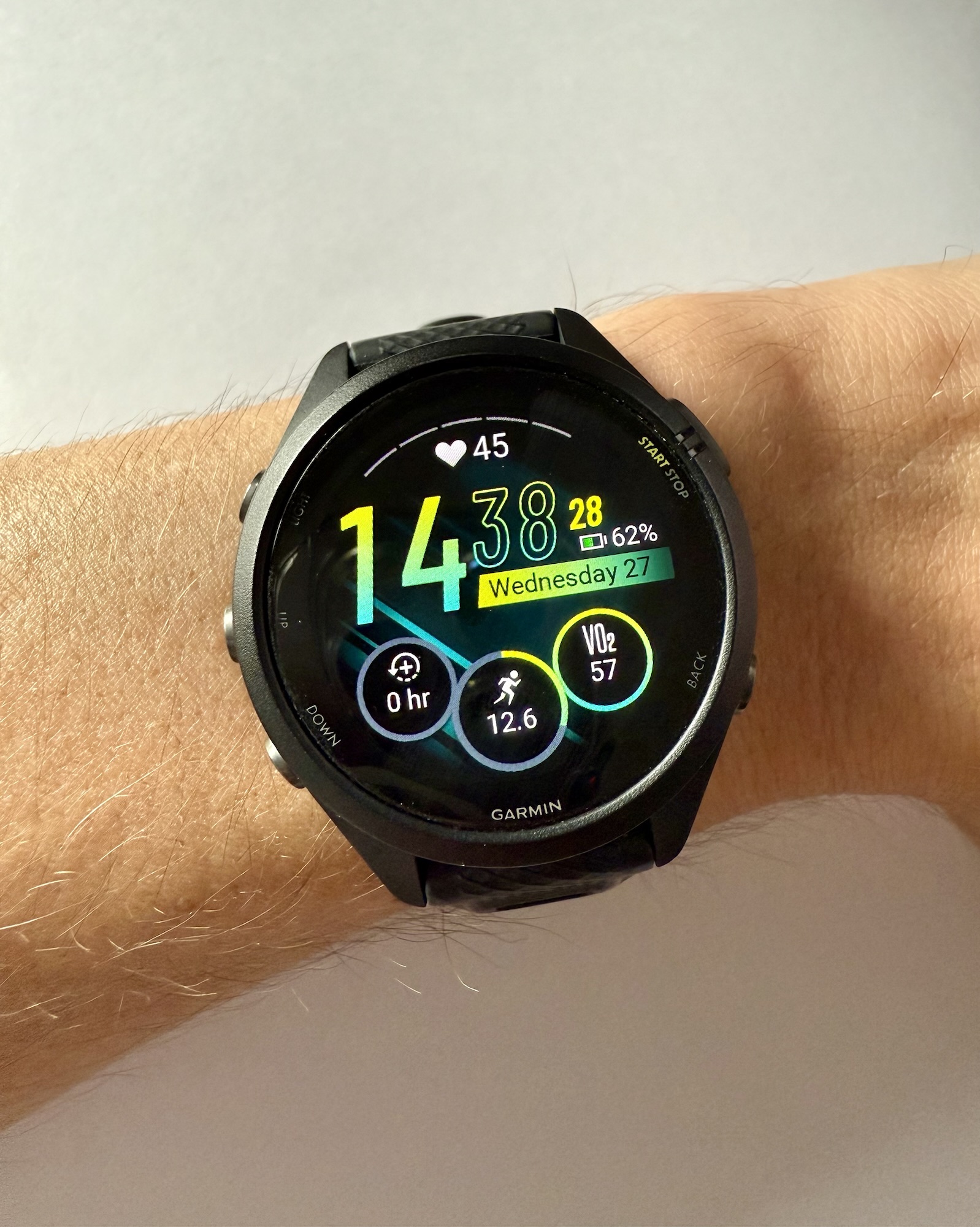 Close-up of a Garmin Forerunner 265S smartwatch worn on a runner’s wrist, displaying its lightweight design and clear screen.